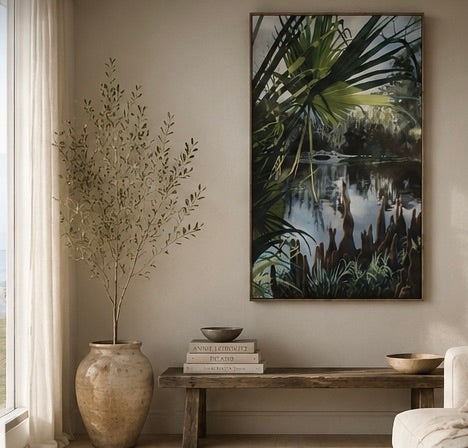 Living room with a large painting of a natural scene, a vase with branches, and a wooden bench.