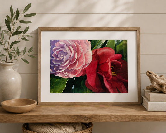 Framed artwork of pink and red flowers on a wooden shelf with decorative items.